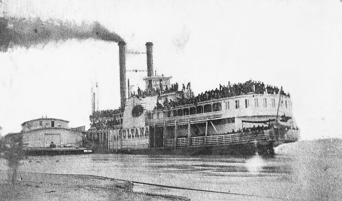 Historic steamboat filled with passengers on a river, representing lesser-known historical events and moments.