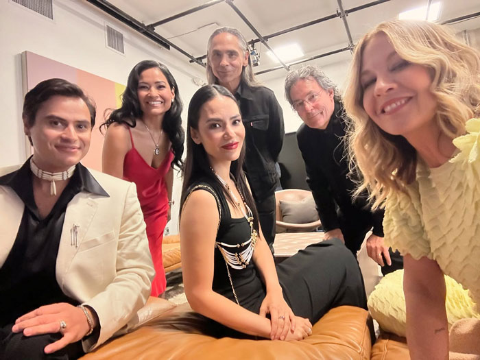 Group photo featuring a famous 90s actress aged 53 with a youthful look during a rare public outing indoors.