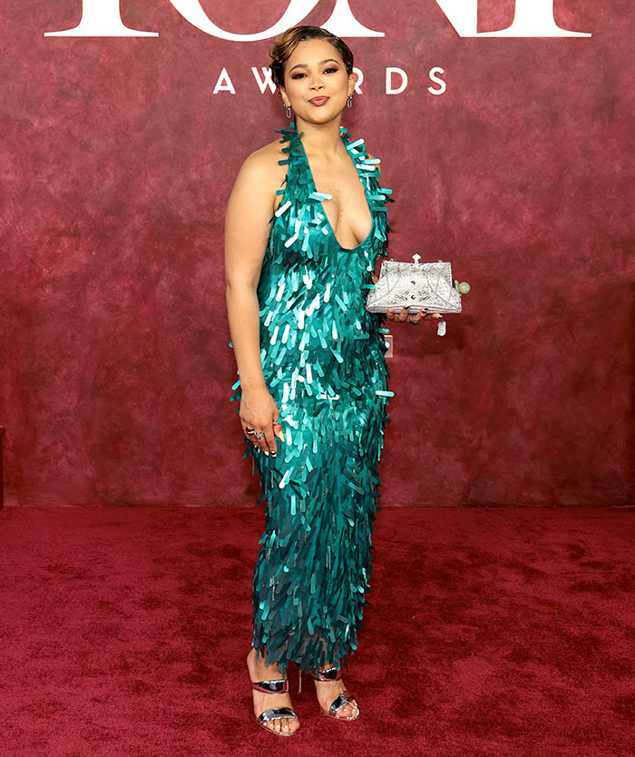 Woman in teal embellished dress and silver heels posing on the worst dressed stars 2025 Tony Awards red carpet.