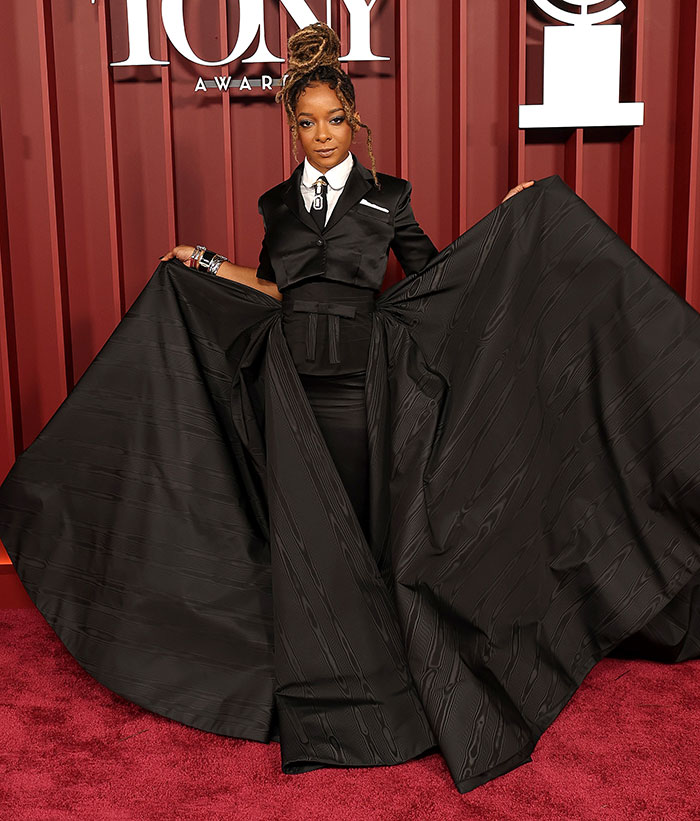 Woman in an oversized black dress and suit jacket posing on the 2025 Tony Awards red carpet worst dressed stars.