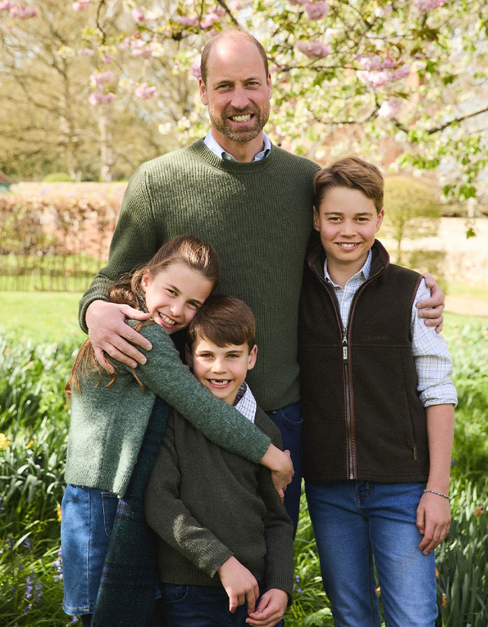 Prince William with his children smiling outdoors in casual clothes, a heartwarming family moment on his birthday.