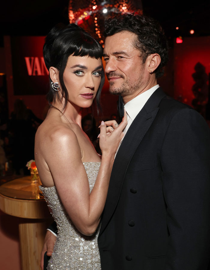 Katy Perry and Orlando Bloom posing closely at an event following their breakup and her telling message post.
