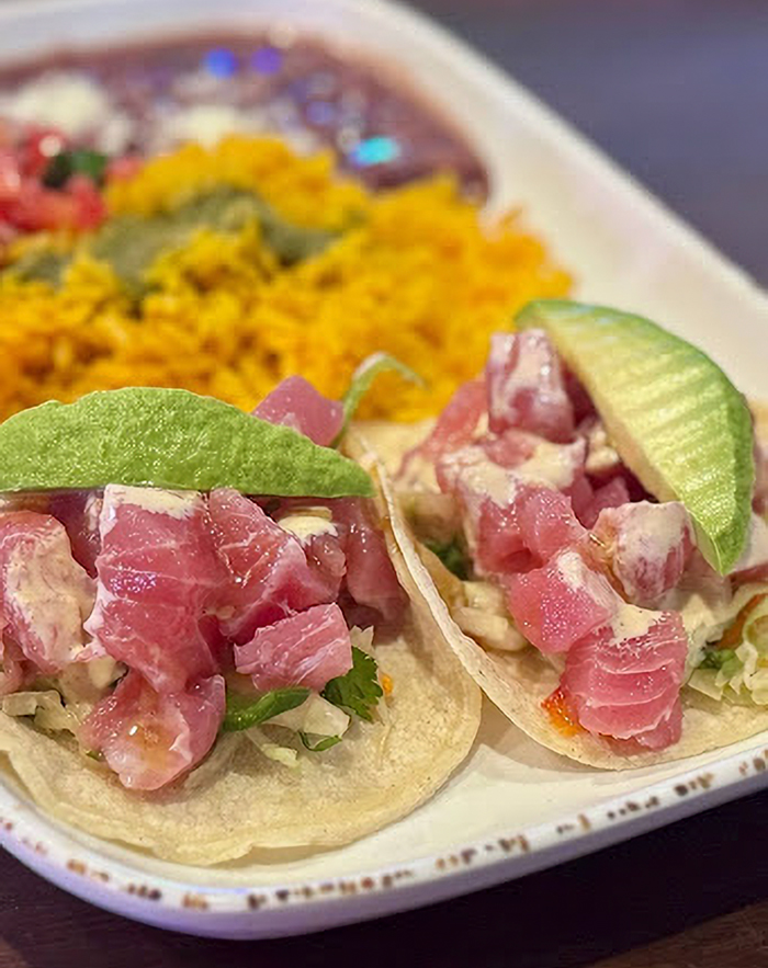 Fresh tuna tacos topped with lime slices served with yellow rice, showcasing a foodie’s guide to Siesta Key hidden gems. Fresh tuna tacos topped with lime slices served with yellow rice, showcasing a foodie’s guide to Siesta Key hidden gems.