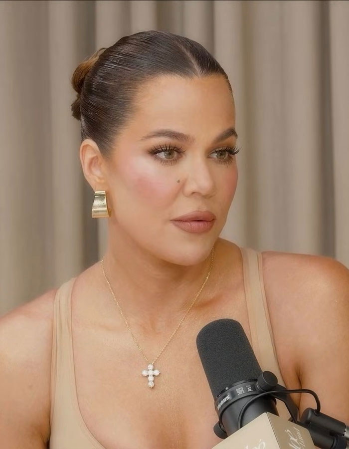 Khloé Kardashian speaking into a microphone, addressing weight loss trolls amid Ozempic speculation in a casual setting. Khloé Kardashian speaking into a microphone, addressing weight loss trolls amid Ozempic speculation in a casual setting.