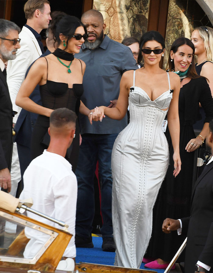Kylie Jenner at a wedding celebration wearing a corset-style dress, breaking a major wedding rule with her outfit choice.