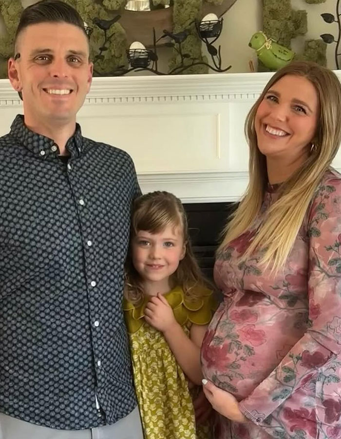 Family portrait with pregnant woman, child, and man, illustrating real housewives exec and childbirth tragedy context.