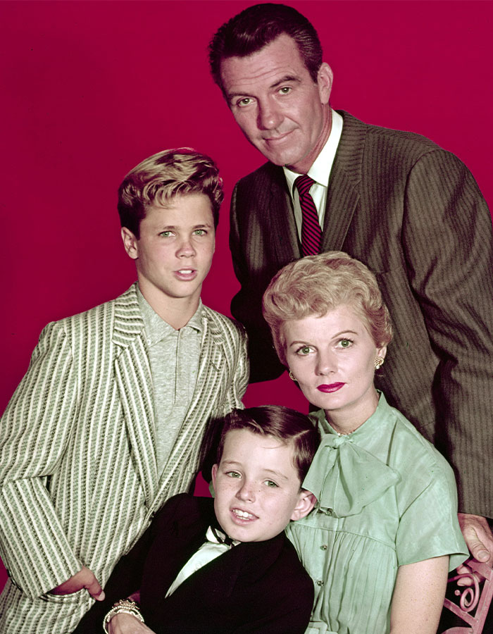 Cast of beloved 50s show posing together in vintage attire with smiles, capturing iconic moments from the classic TV series. Cast of beloved 50s show posing together in vintage attire with smiles, capturing iconic moments from the classic TV series.