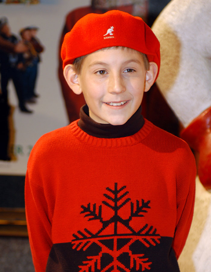 Young boy wearing a red hat and sweater with a snowflake design, related to Malcolm In The Middle Dewey character. Young boy wearing a red hat and sweater with a snowflake design, related to Malcolm In The Middle Dewey character.