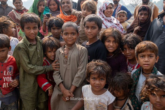 Group of children and adults captured by a photographer revealing the unseen realities of our world in a natural outdoor setting