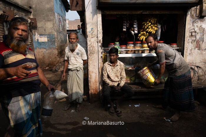 Group of men in a street market, captured by a photographer revealing the unseen realities of our world.