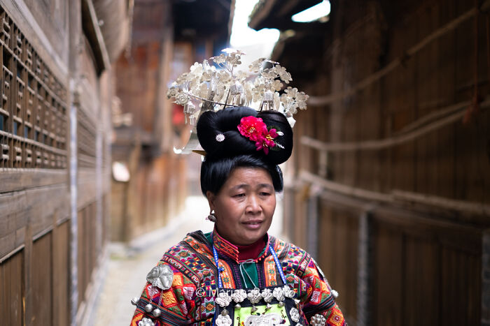 Close-up of a woman in traditional attire, showcasing unseen realities captured by the photographer in vibrant cultural detail.