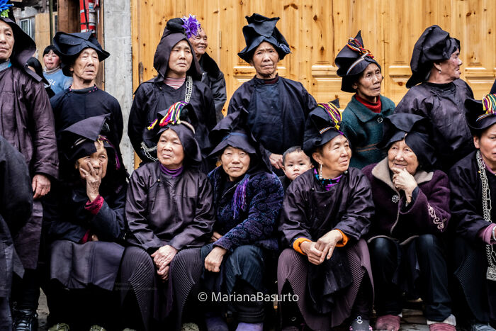 Group of people in traditional attire, showcasing unseen realities captured by the photographer in candid cultural moments.