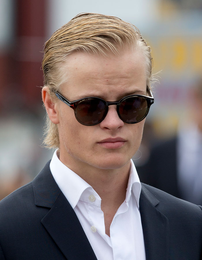 Young man wearing dark sunglasses and a black suit, representing Norwegian Crown Princess&rsquo;s son facing multiple charges.
