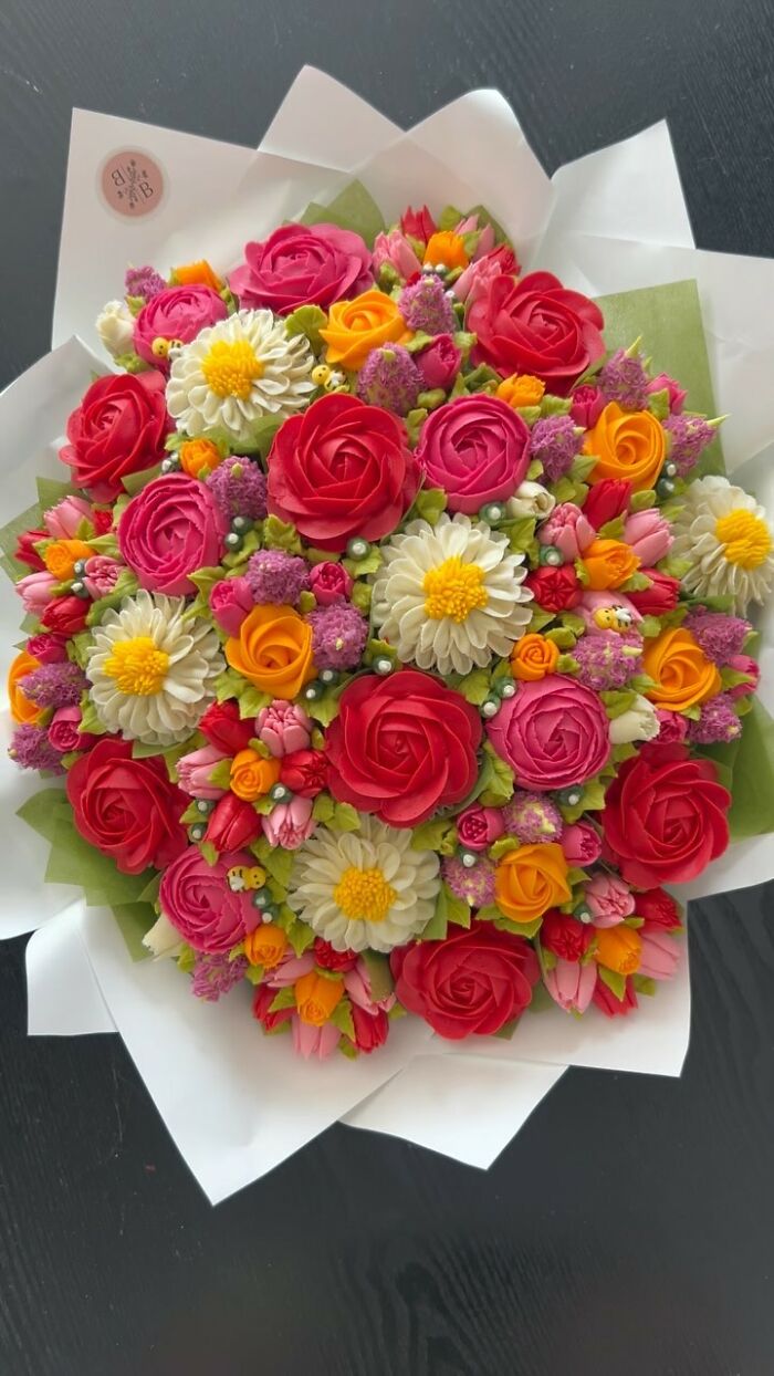 Colorful baked goods bouquet with roses and daisies, intricately designed to look like a flower bouquet by a talented artist