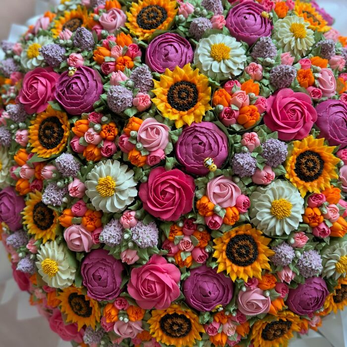 Colorful baked goods resembling flower bouquets including roses, sunflowers, and daisies crafted with detailed frosting art.