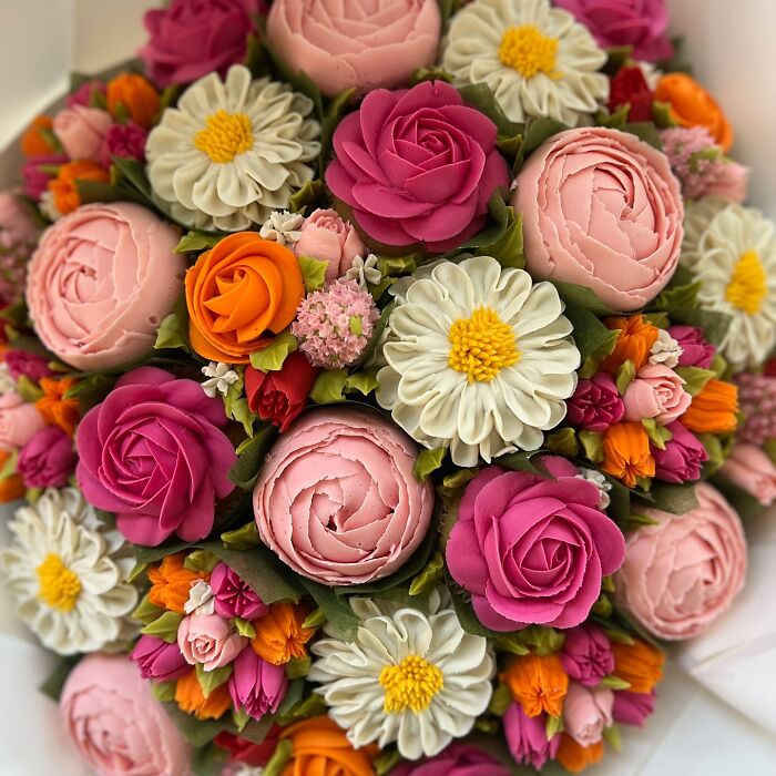Bouquet of baked goods crafted to look like colorful flower bouquets with intricate frosting details