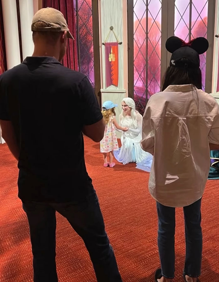 Family at Disneyland interacting with a character, sparking Meghan Markle Disneyland family post backlash online.