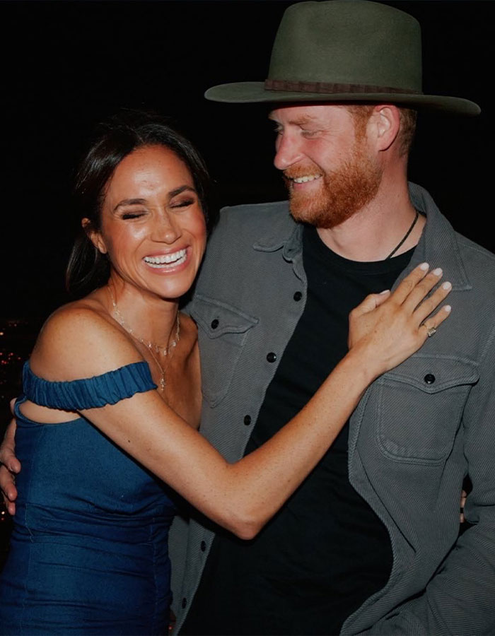 Meghan Markle and her husband smiling and embracing, a Disneyland family moment sparking backlash after pregnancy dance.
