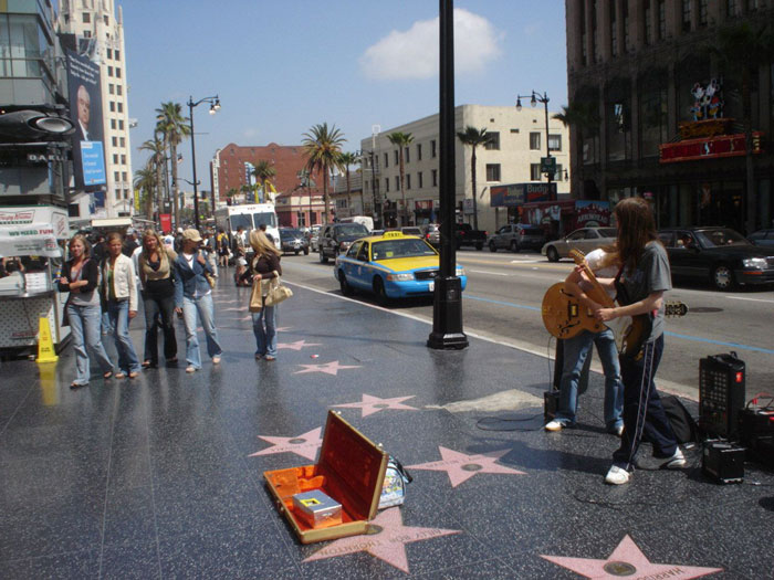 Street musicians performing on Hollywood Walk of Fame as doctors speculate about Miley Cyrus&rsquo; brutal infection root cause.