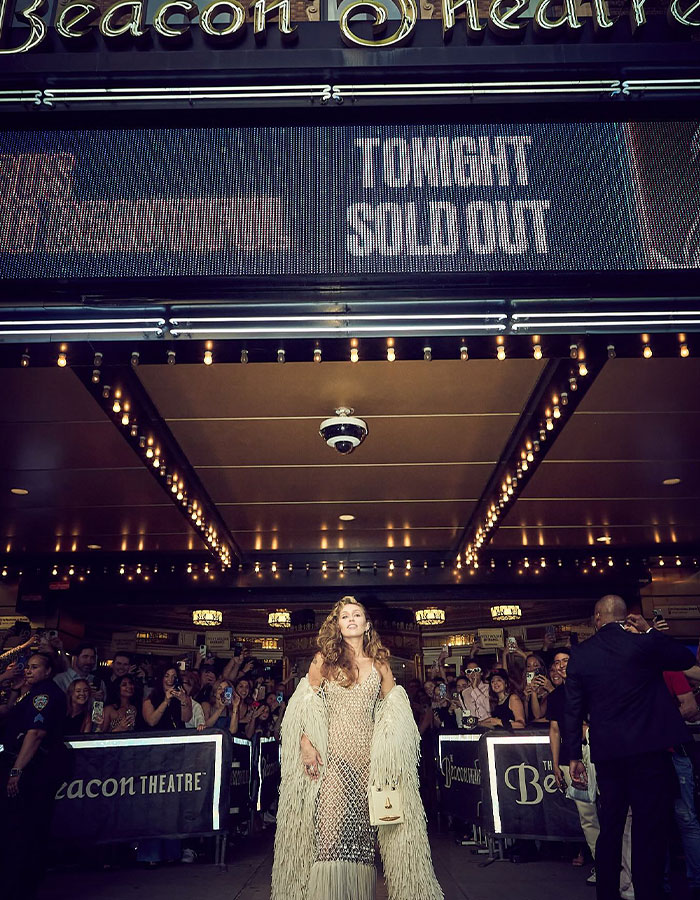 Miley Cyrus at Beacon Theatre premiere with fans and sold out sign highlighting Miley Cyrus booed video premiere event.