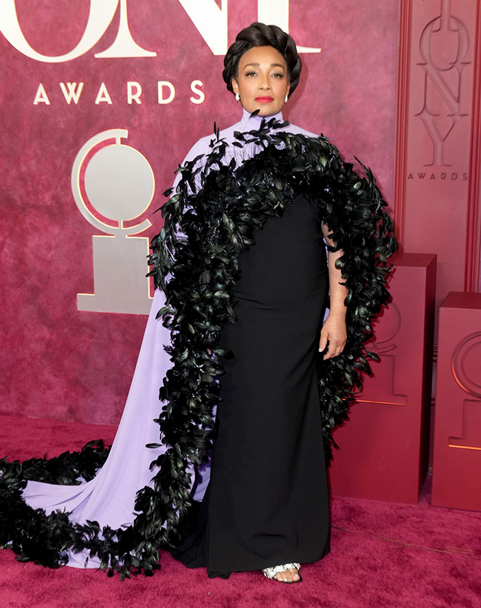 Star in an elaborate black and lavender gown with feathered detailing on the 2025 Tony Awards red carpet worst dressed list.