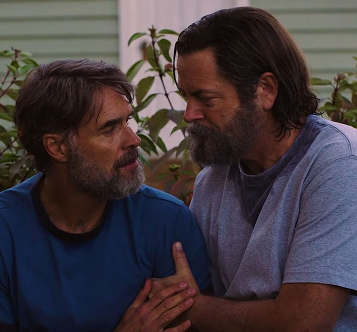 Two men with beards in an emotional moment outdoors, illustrating themes from Nick Offerman and Michael Flynn's son Parks and Rec post. Two men with beards in an emotional moment outdoors, illustrating themes from Nick Offerman and Michael Flynn's son Parks and Rec post.