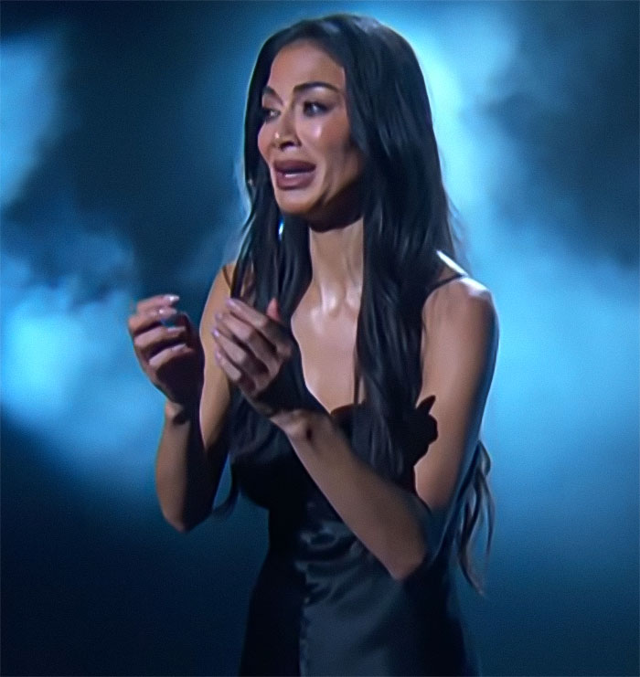 Nicole Scherzinger in a black dress with long hair, highlighting her transformation as doctors note possible Ozempic side effects.