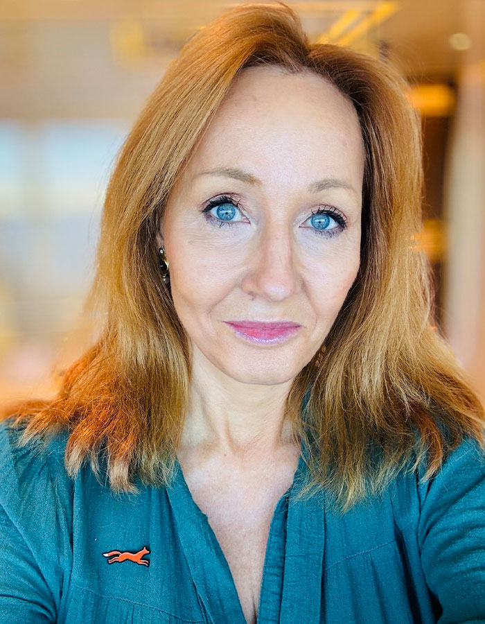 J.K. Rowling with blue eyes and light brown hair, wearing a teal top, linked to Death Eater claims and Pedro Pascal mockery. J.K. Rowling with blue eyes and light brown hair, wearing a teal top, linked to Death Eater claims and Pedro Pascal mockery.