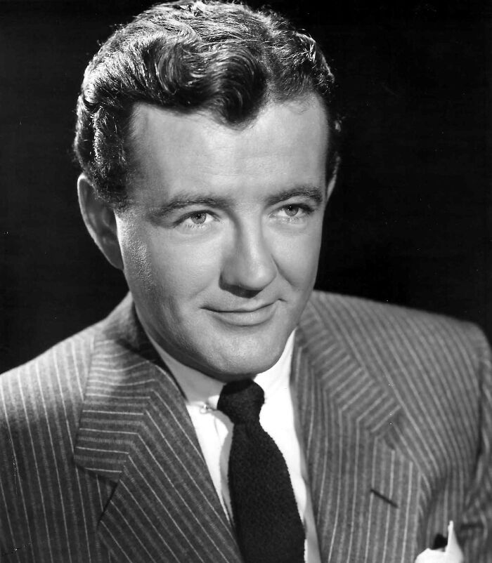 Black and white portrait of a 20th century star wearing a pinstripe suit and tie, representing stars lost too soon.