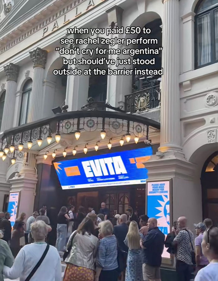 Crowd outside theater showing Rachel Zegler performing on screens, sparking outrage over $500 live show tickets.