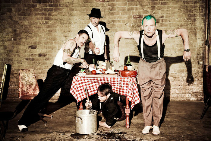 Four men with vintage style and tattoos around a table with a checkered tablecloth, evoking best I was there moments.