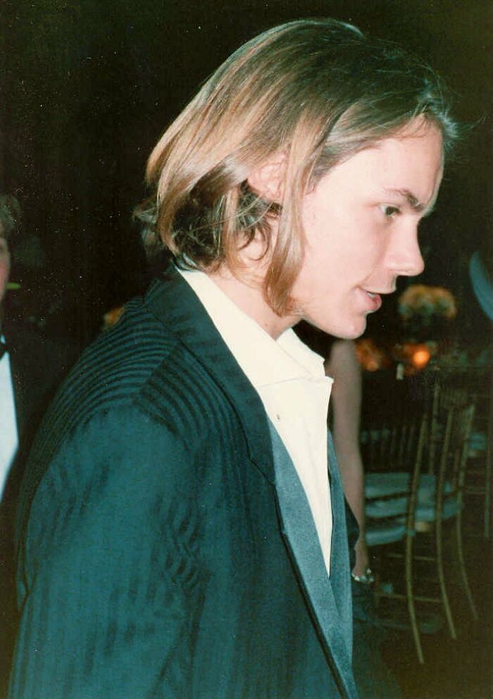Young man with medium-length hair in a suit jacket at an indoor event, part of stars we lost too soon collection.