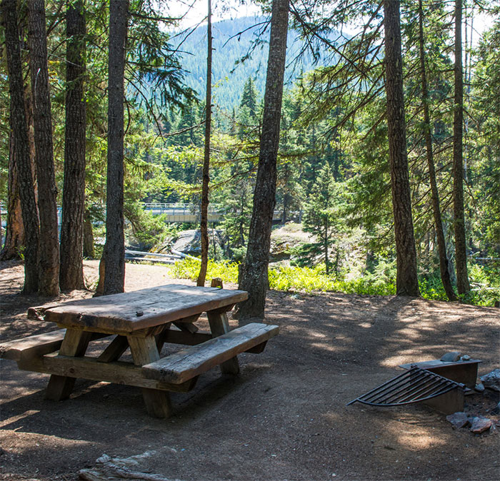Picnic area in forest near mountains, setting resembling planned visitation site linked to bodies of 3 missing sisters found.