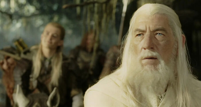 Scene from a film featuring an elderly man with long white hair and beard in a fantasy setting, iconic in greatest films.