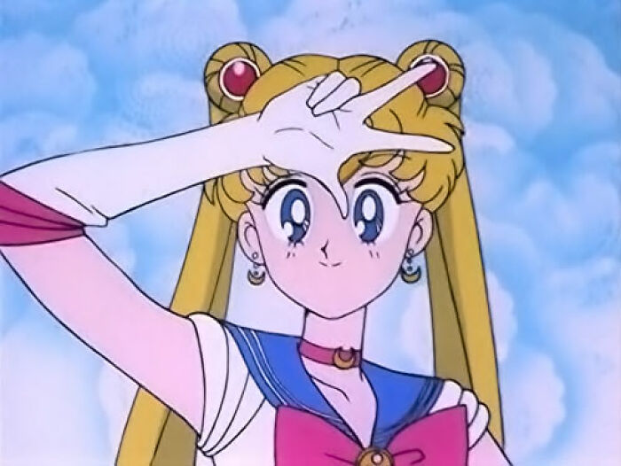 Animated character Sailor Moon making a hand gesture with a bright sky background, capturing memorable moments shared.