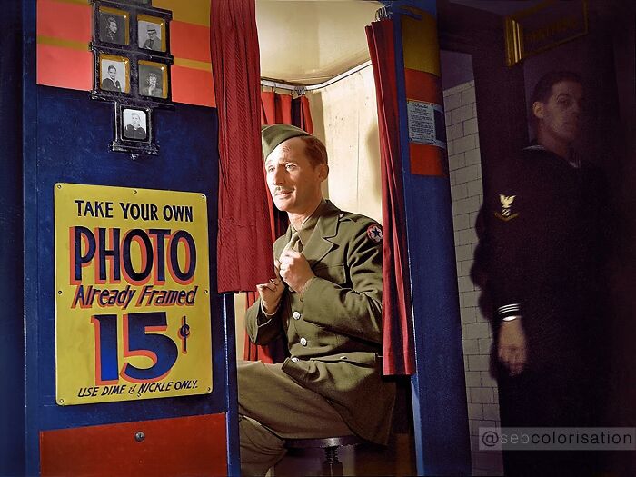 Colorized historical photo of a soldier in uniform sitting in a photo booth, showcasing magical historical photos by a viral artist.