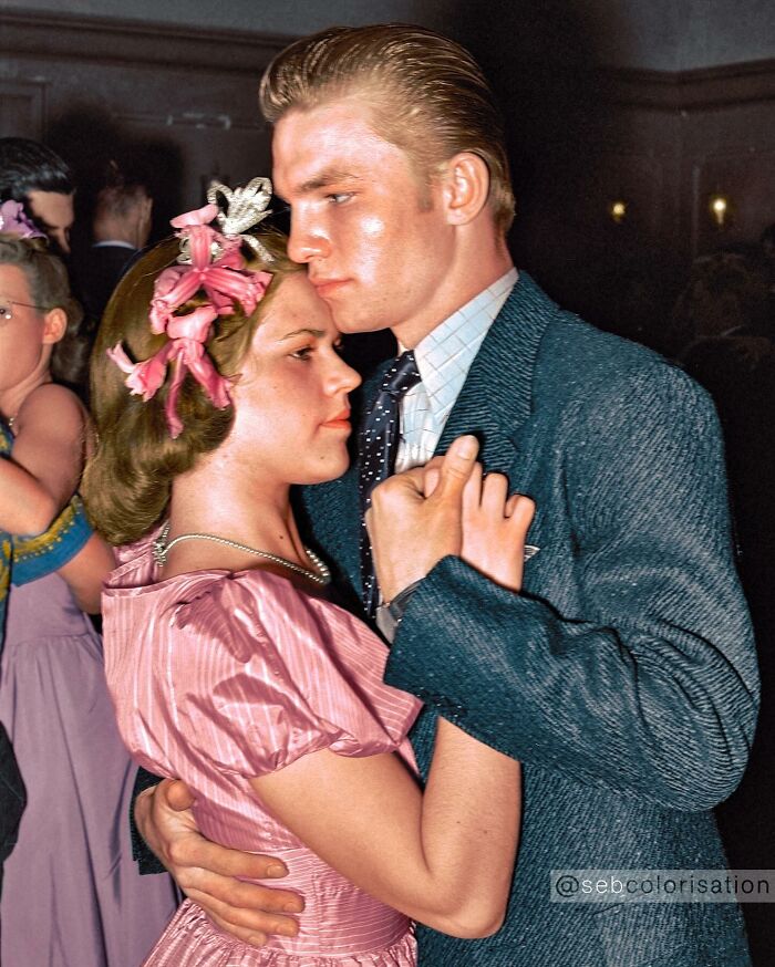 Young couple dancing closely at a formal event, a magical historical photo colorized by a talented viral artist.