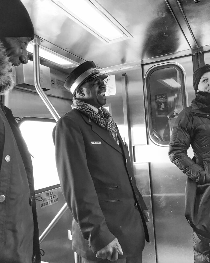 Chicago teacher captures intimate street photo of a smiling transit worker on a train, showcasing the city’s authentic spirit.