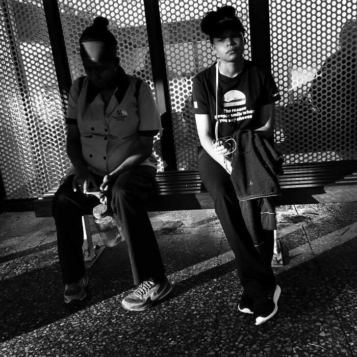 Two people sitting on a bench in Chicago, captured in an intimate street photo showing the city’s soul.