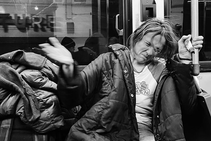Black and white street photo capturing a woman on public transit, showcasing intimate Chicago street photography moments.
