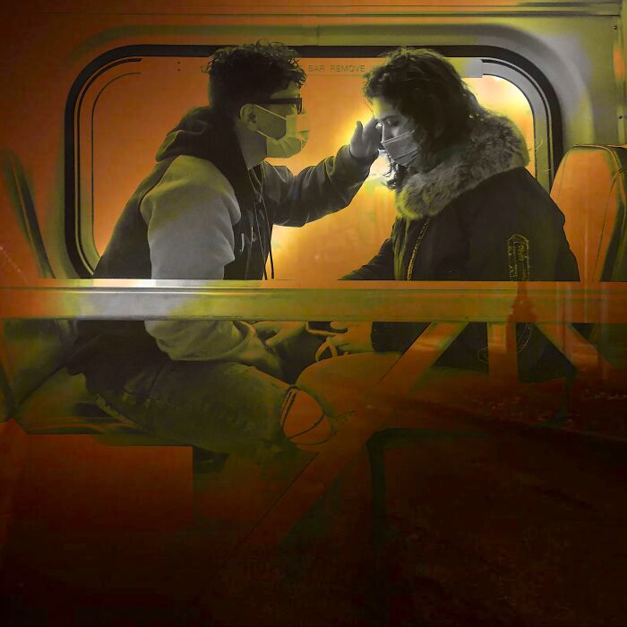 Young couple wearing masks sharing an intimate moment on a Chicago street, capturing the city’s soul through photography.