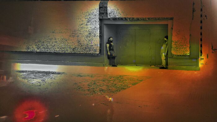 Two individuals stand near an industrial building at night in a Chicago street photo capturing the city’s soul.