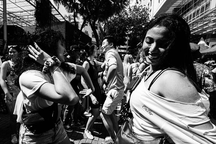 Candid street photo capturing joyful people dancing and enjoying the quiet beauty of everyday life outdoors.