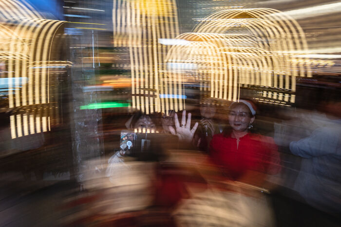 Blurred candid street photo of people in a lively urban setting capturing the quiet beauty of everyday life.