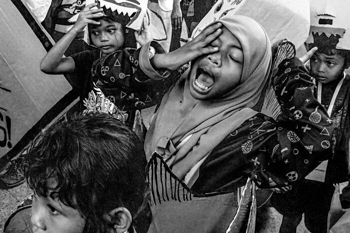 Children in candid street photos showing expressive moments that capture the quiet beauty of everyday life.