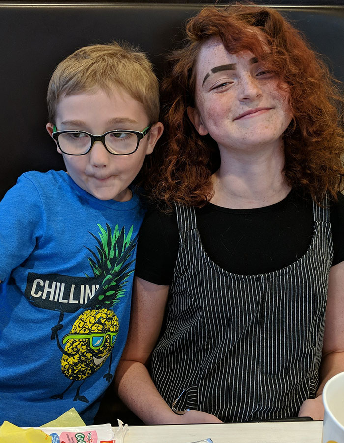 Two children sitting together at a table, highlighting parents of 19-year-old issuing urgent dusting challenge warning.