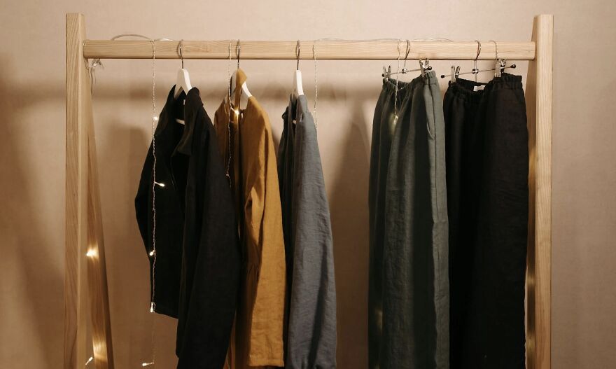 Clothes hanging on a wooden rack with soft lighting, illustrating a then vs now poll concept.