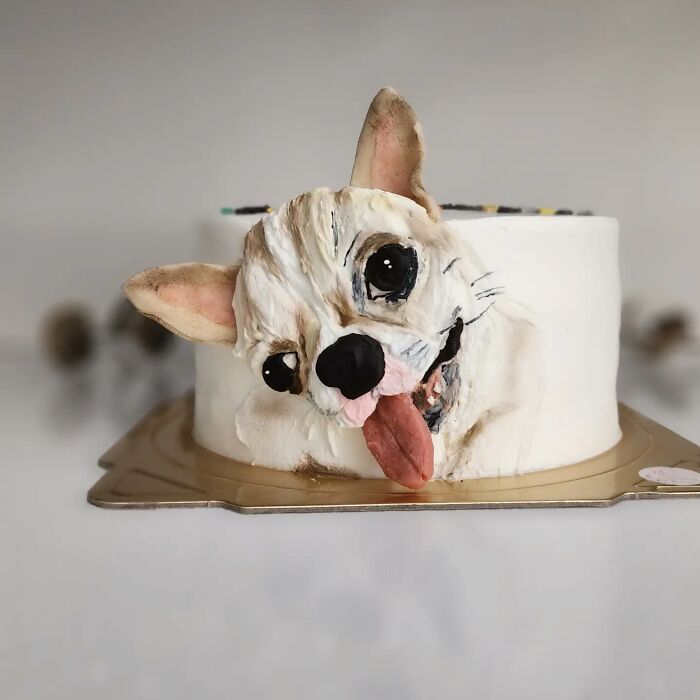Cake featuring a detailed pet-themed dog design with a playful expression, showcasing adorable pet-themed cake artistry.