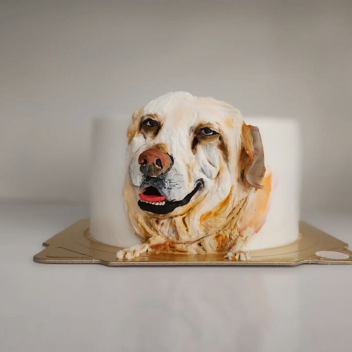Pet-themed cake featuring a detailed and adorable dog face capturing its unique personality by talented artist.
