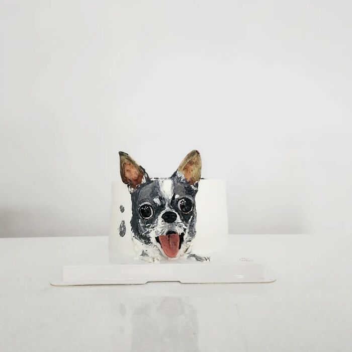 Pet-themed cake shaped like a happy dog with detailed features capturing the unique personality in edible art.